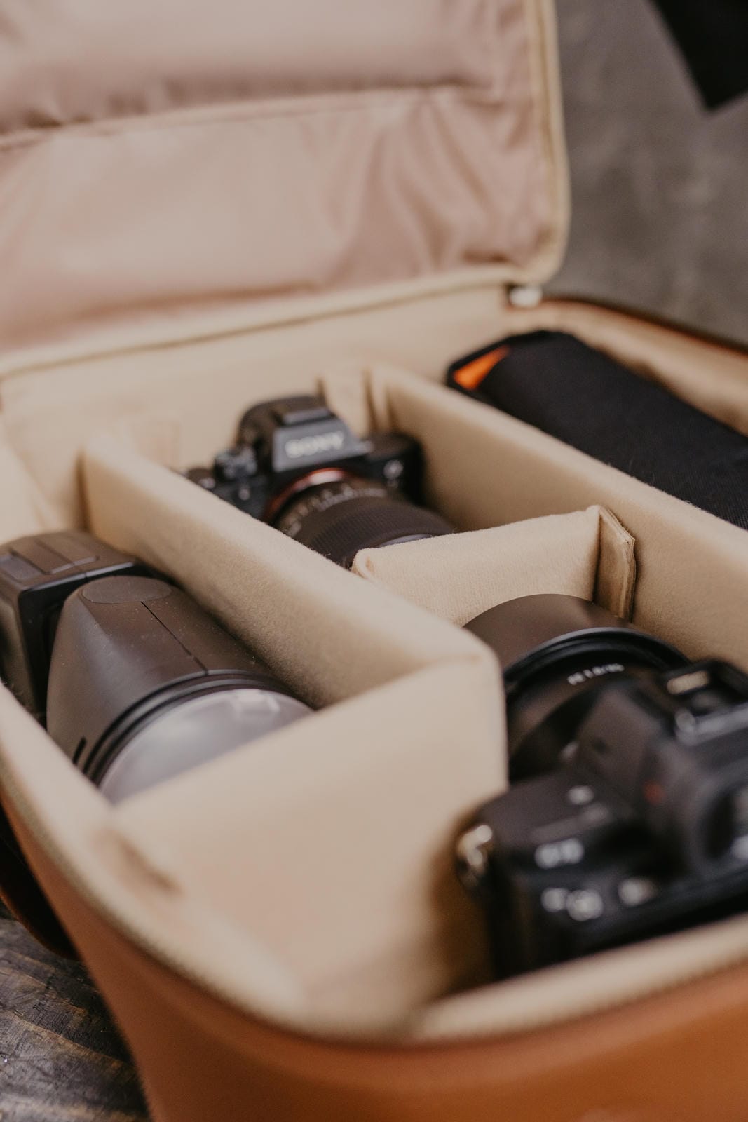 Camera equipment inside a beige travel case