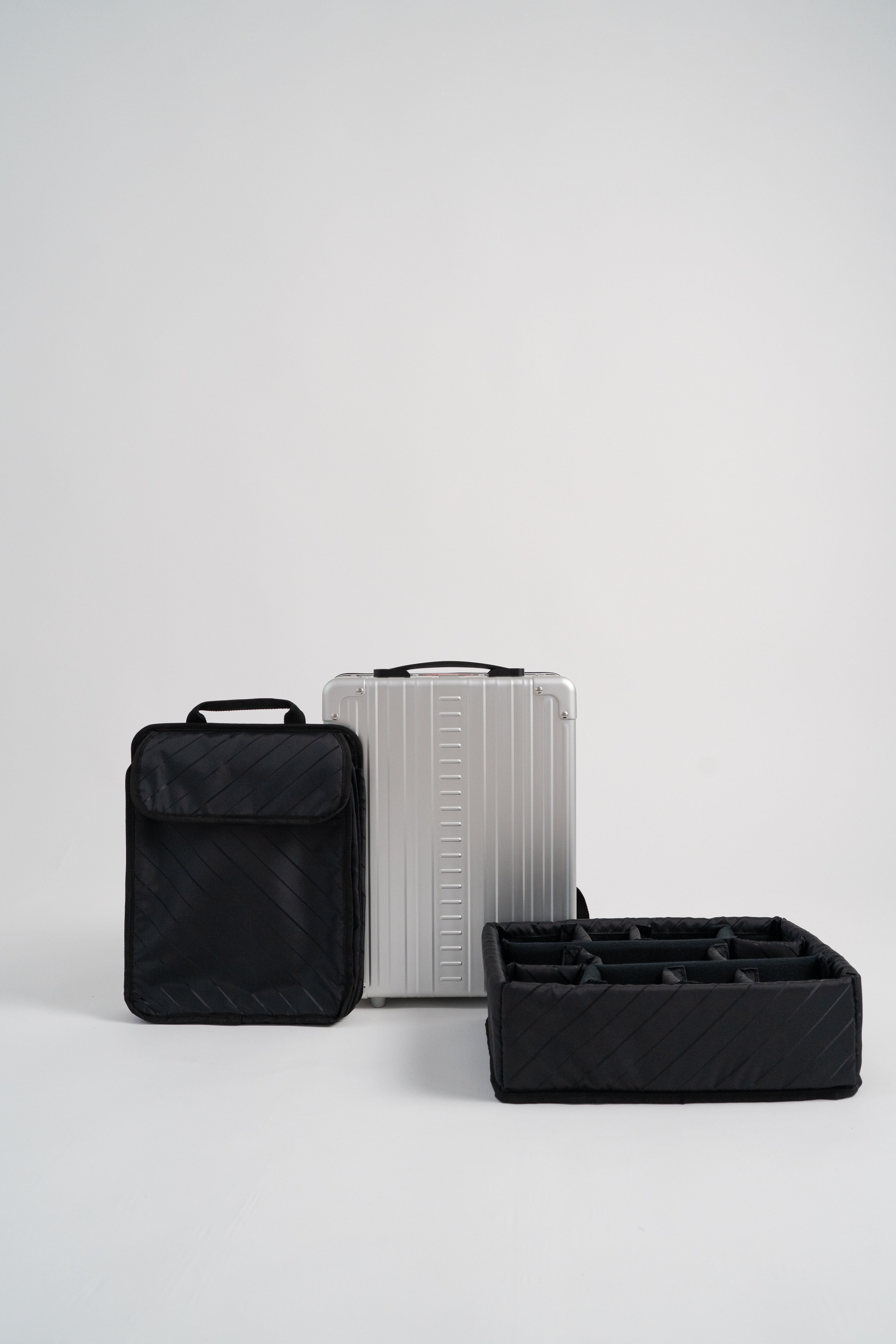 Set of black and gray luggage on a light gray background