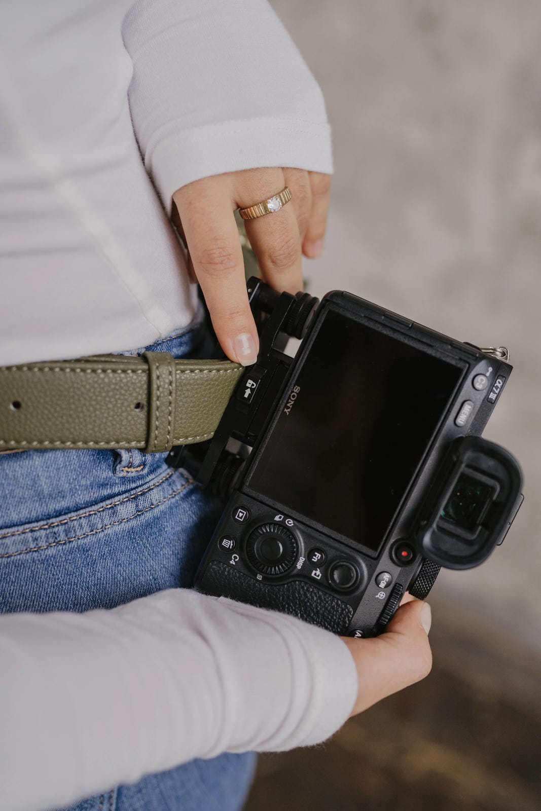 Person holding a camera with a blurred background