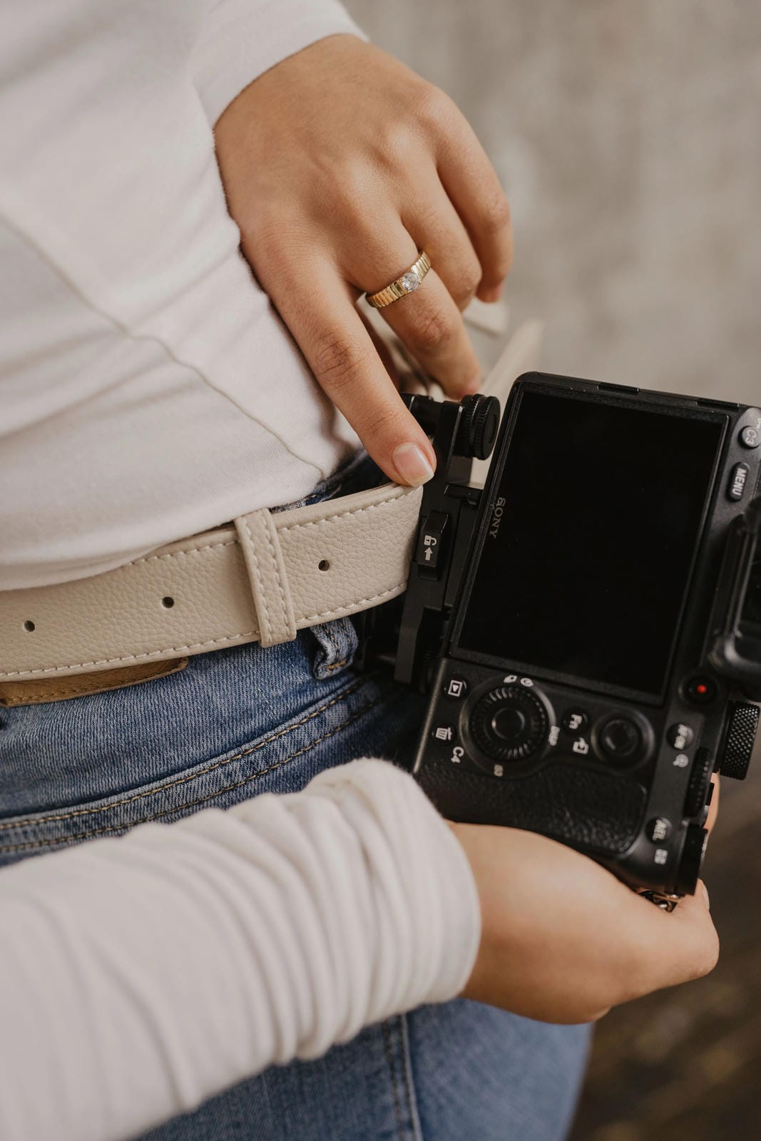Person holding a camera with a blurred background