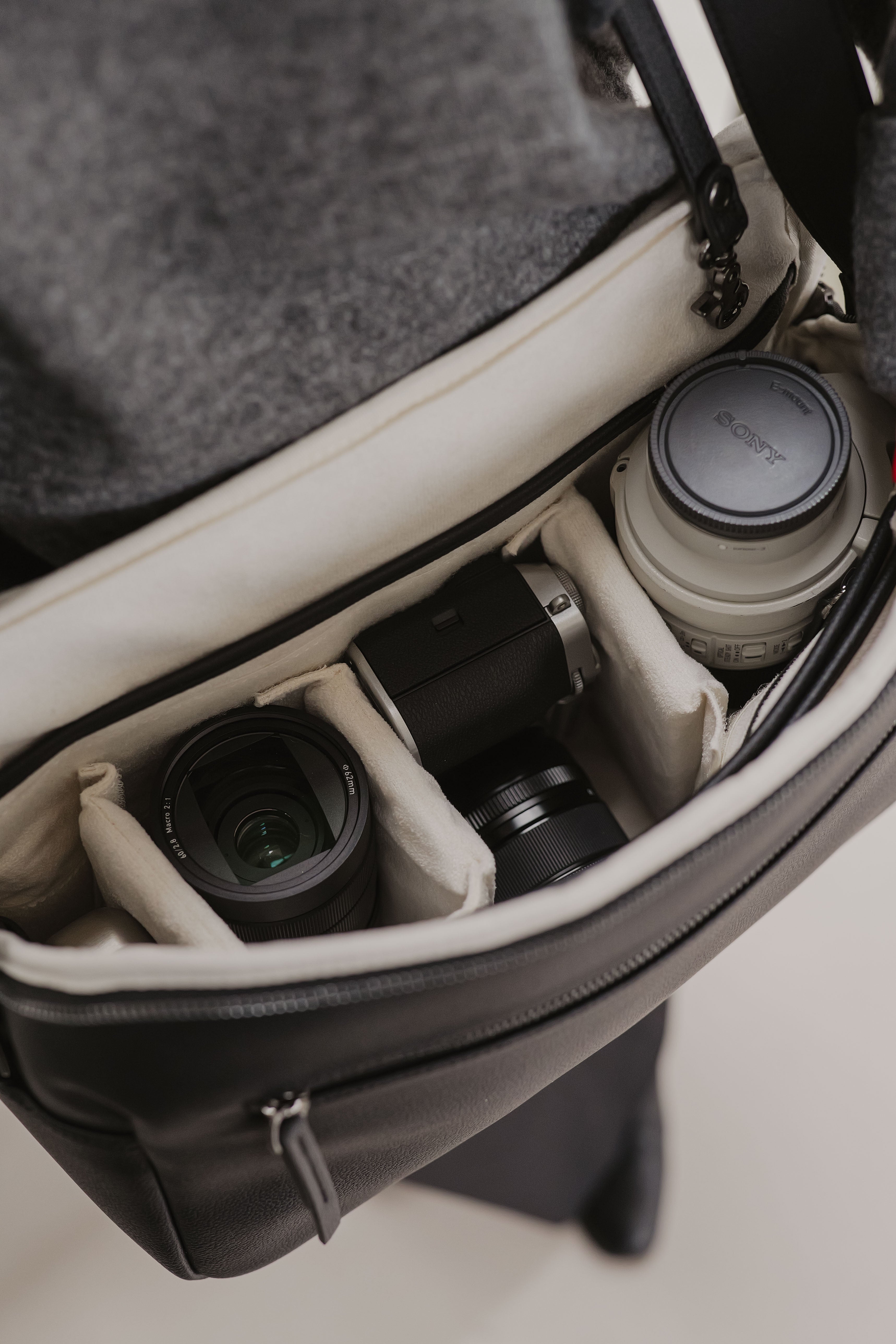 Camera equipment and coffee cup inside a bag