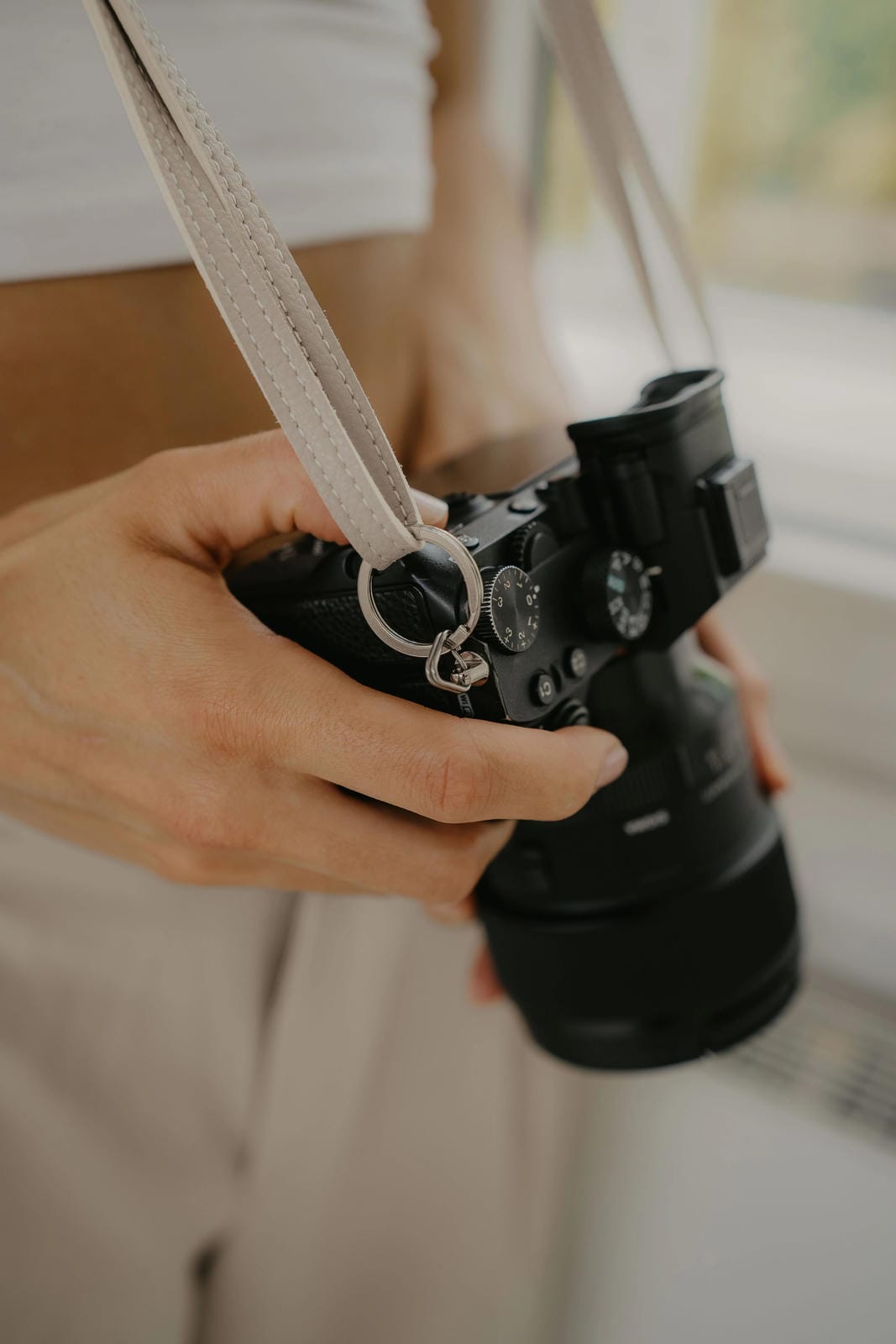 Person holding a camera with a blurred background