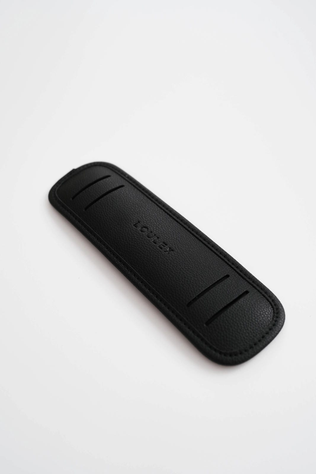 Black leather knife sheath with 'Leather' branding on a white background