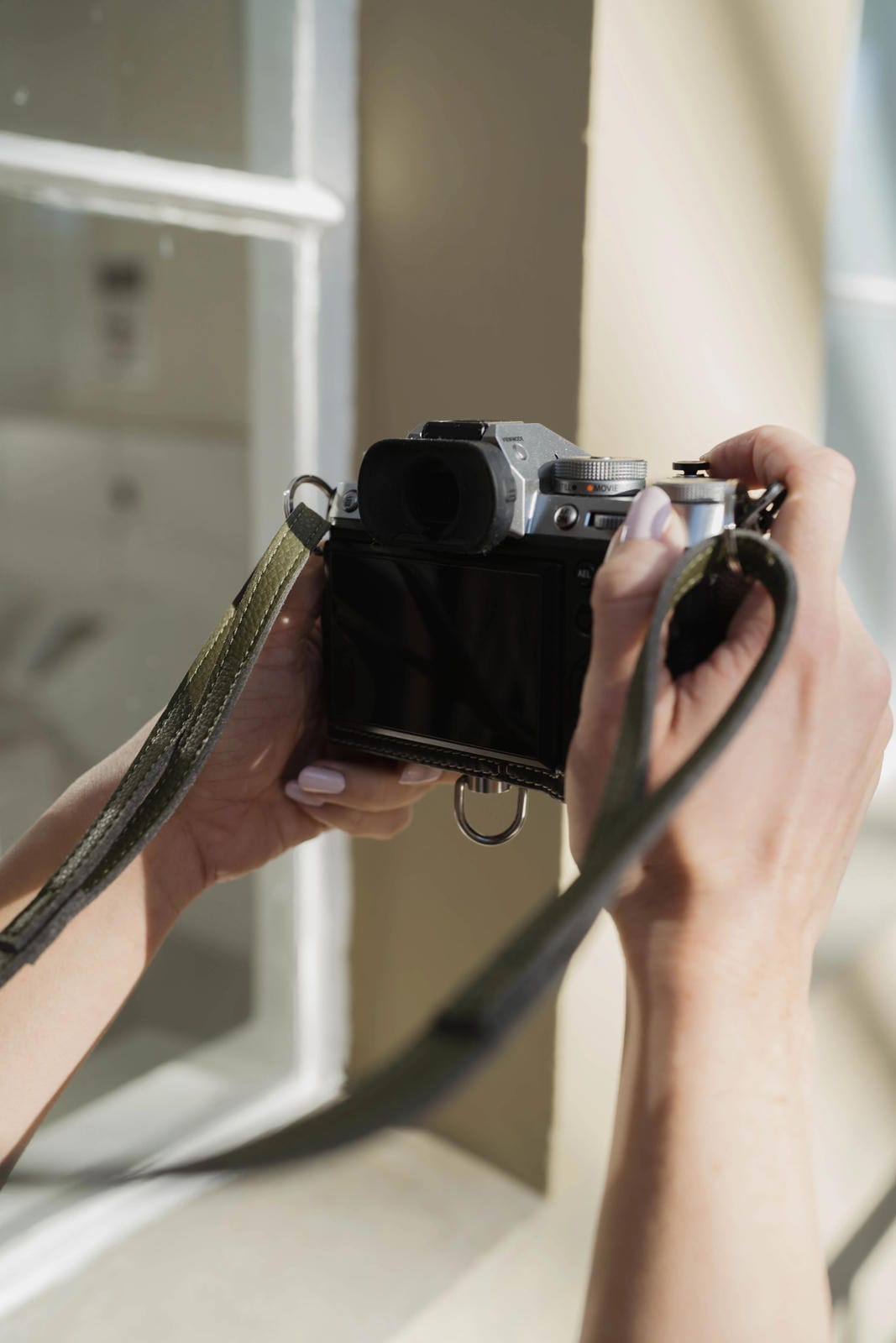 Person holding a vintage camera with a blurred background