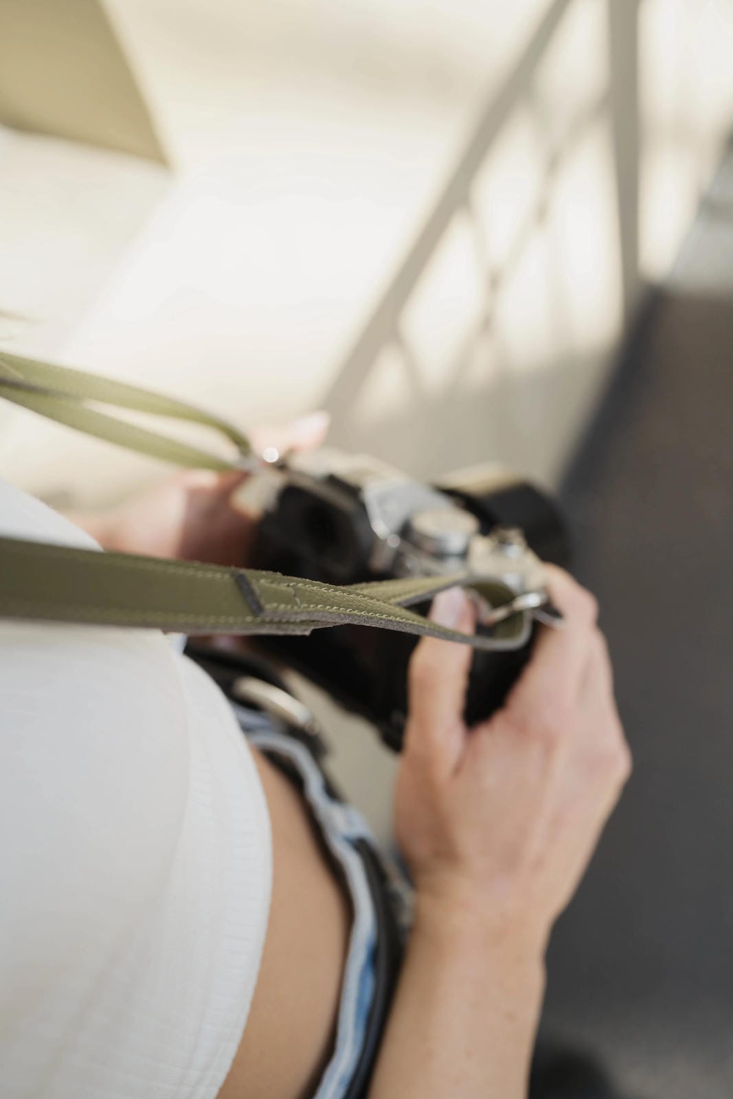 Person adjusting a seat belt in a vehicle