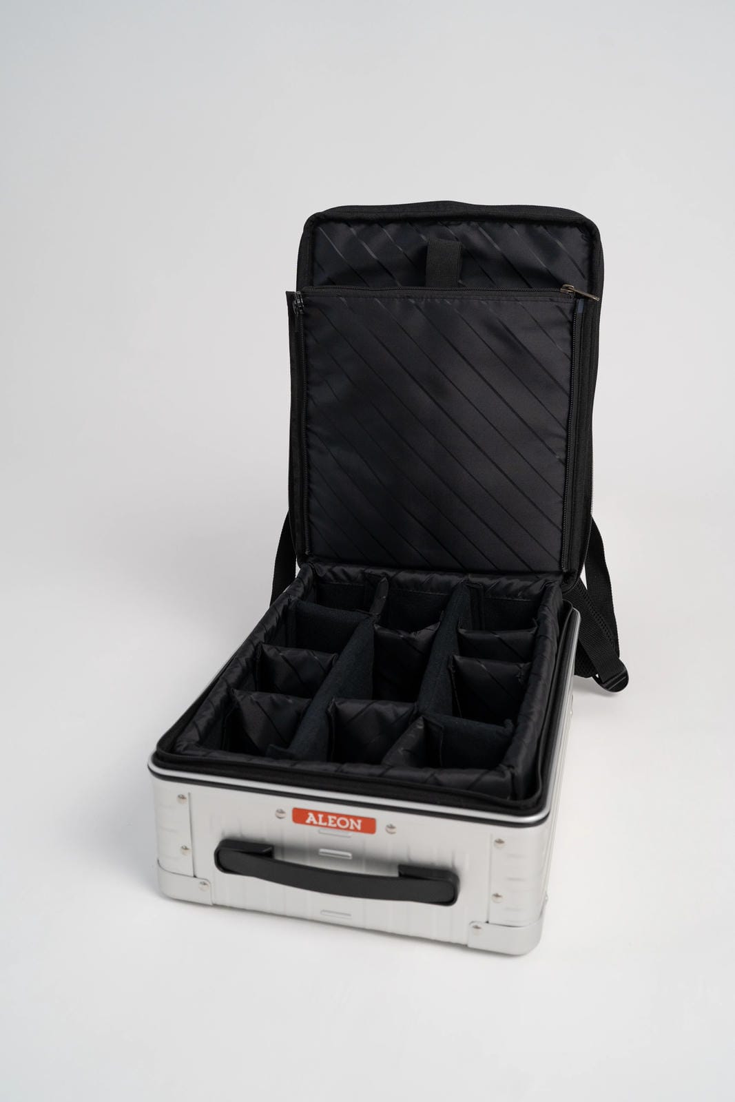 Black carrying case with compartments on a white background
