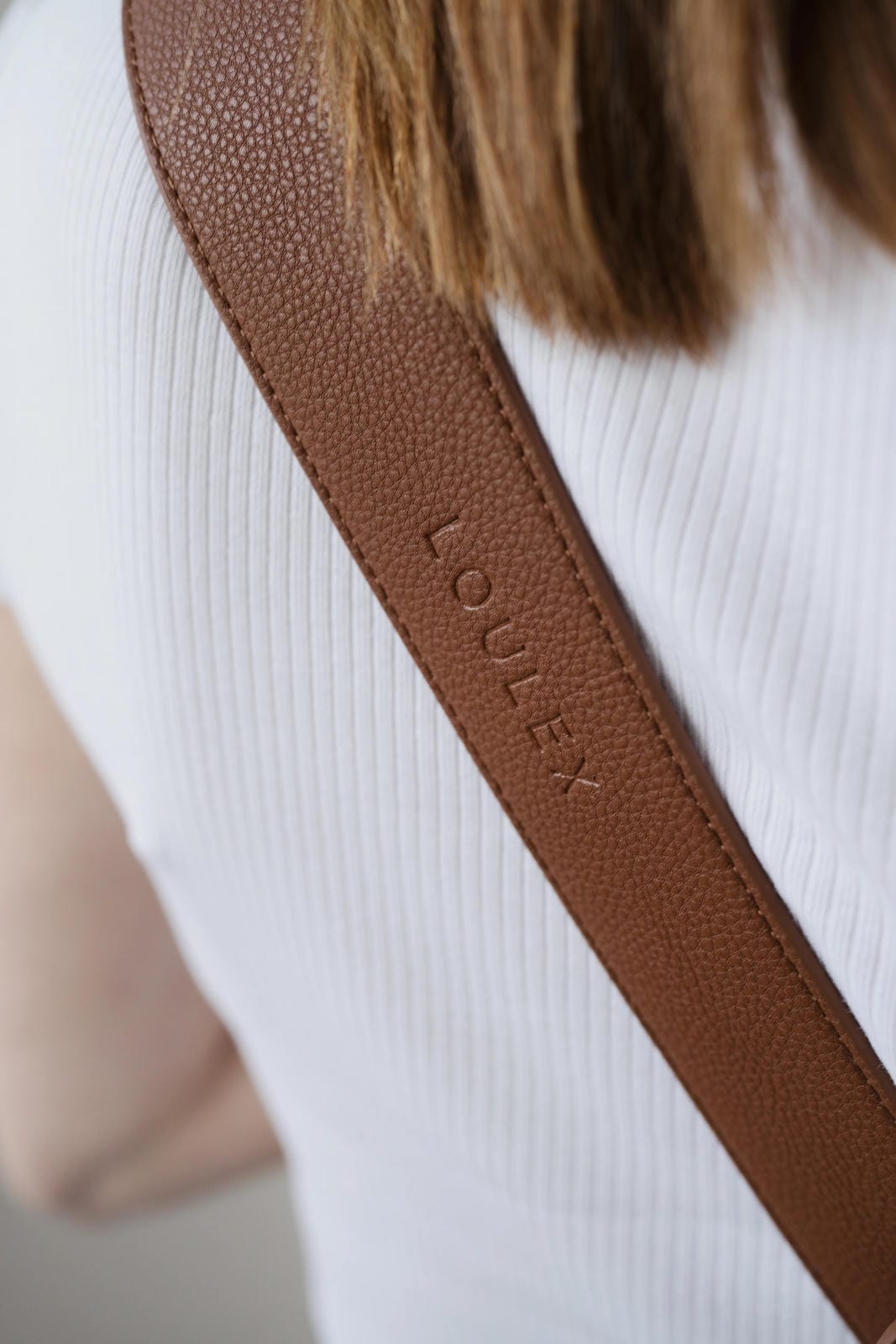 Brown strap with 'LOULEX' branding on a white background