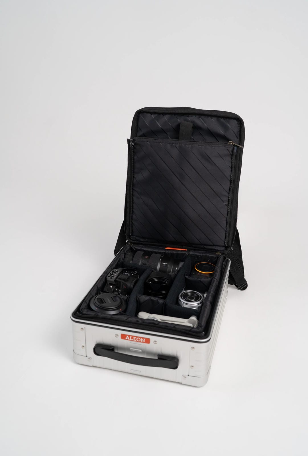 Open black case with various items on a white background