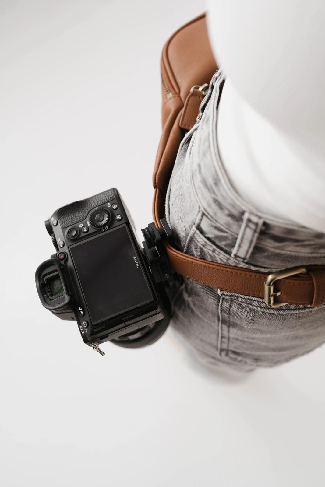 Camera attached to a belt on a white background