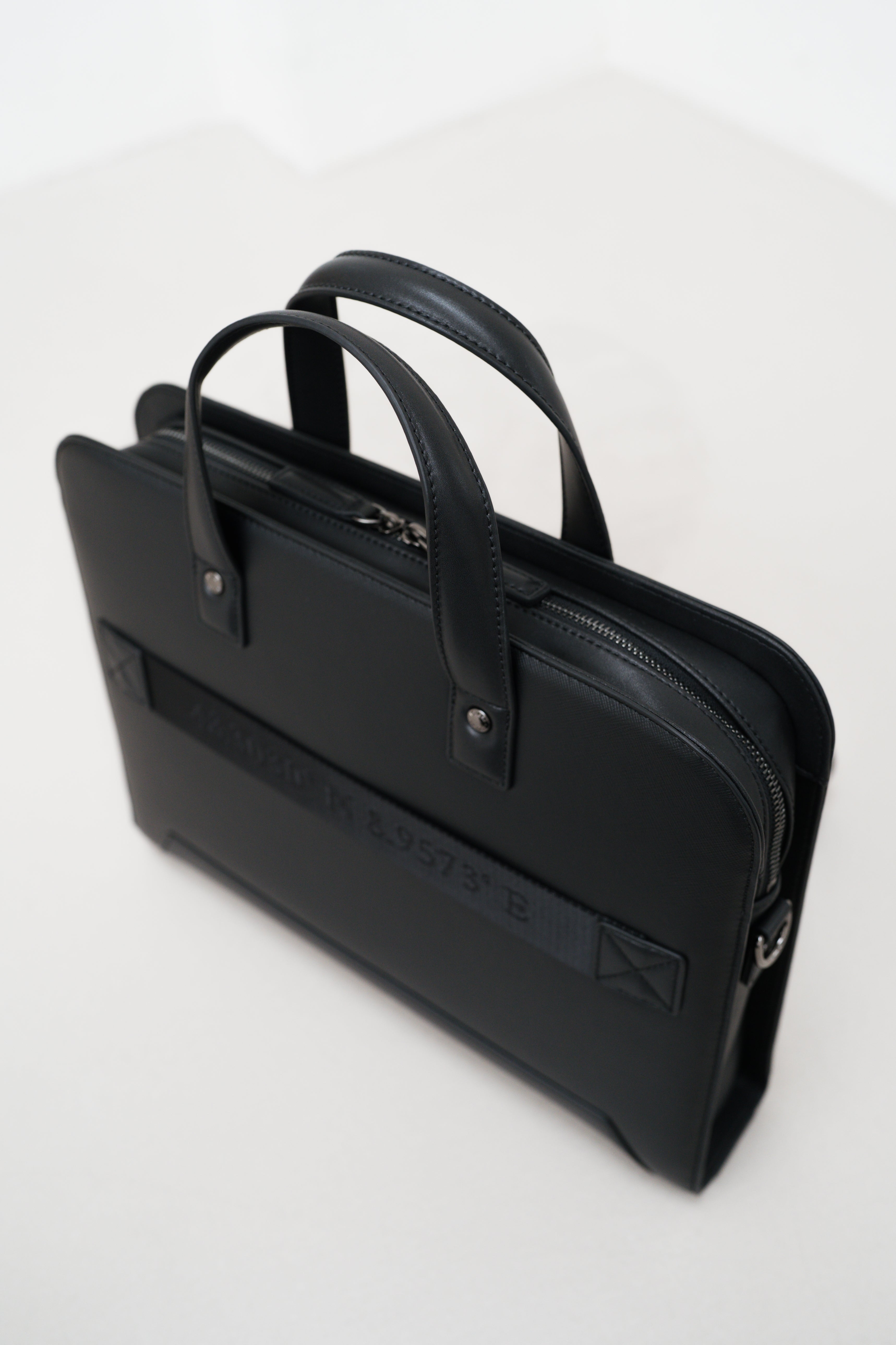 Black leather briefcase on a white background