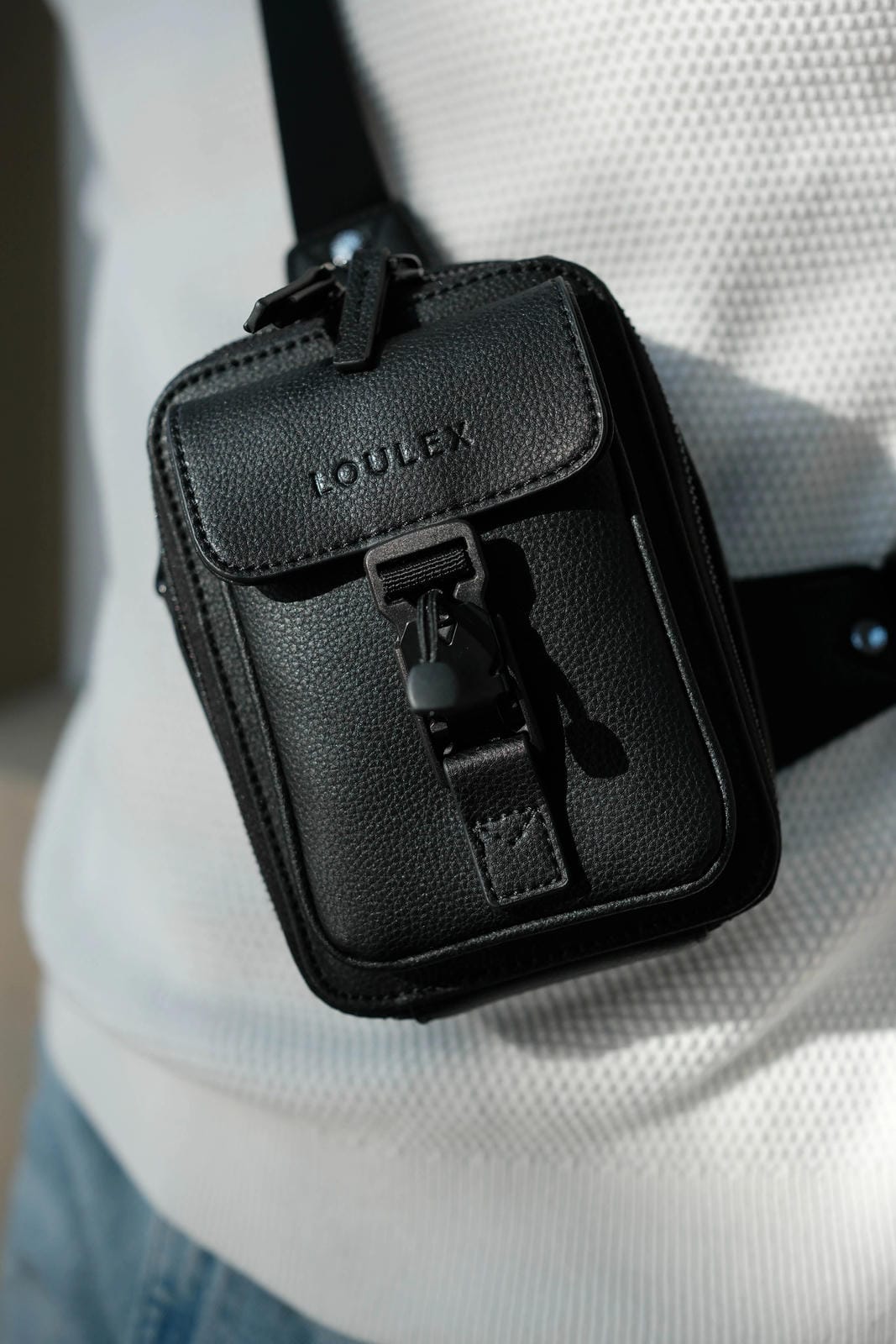 Black pouch with 'LOULEX' branding worn over a shoulder.