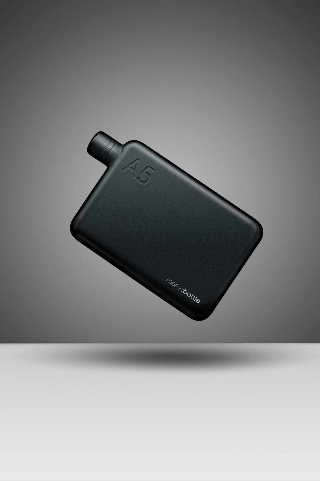 Black portable water bottle on a gray background