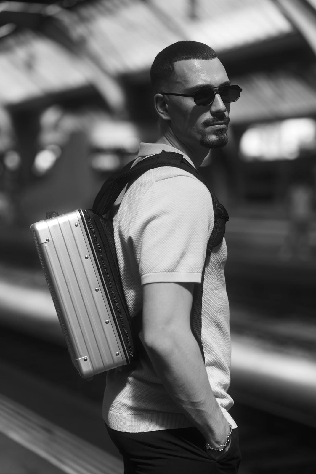 Man with a backpack and sunglasses in an urban setting